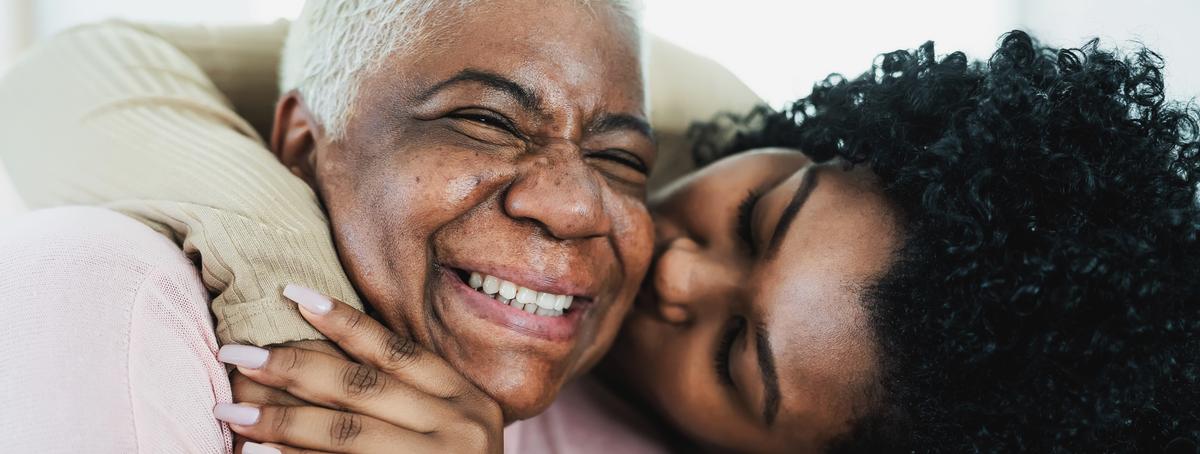 Woman hugging elderly woman