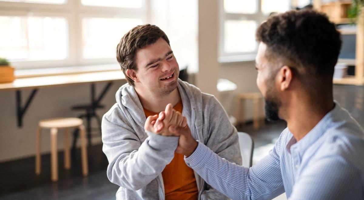 Young man with down syndrome and friend