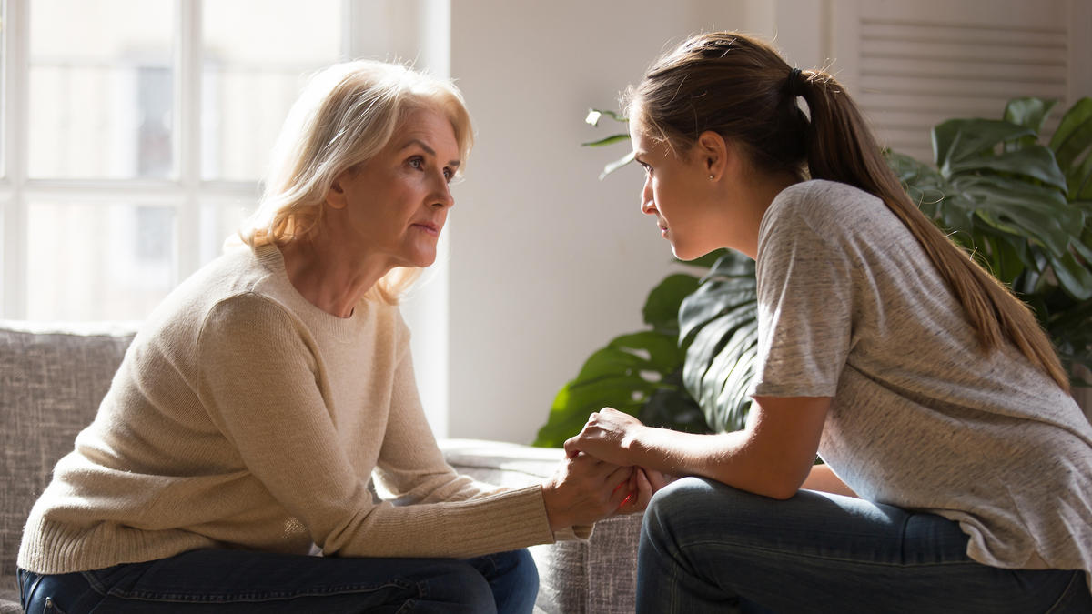 elderly woman speaking young woman grandmother