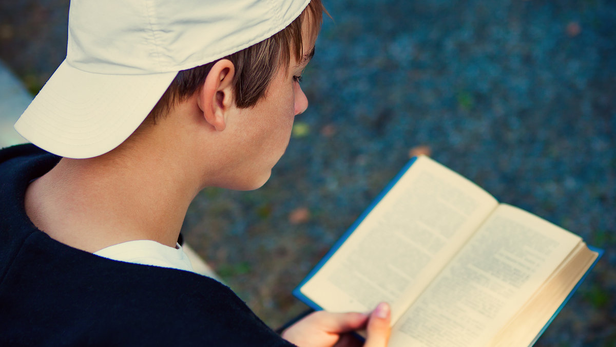 Teenager reading a book