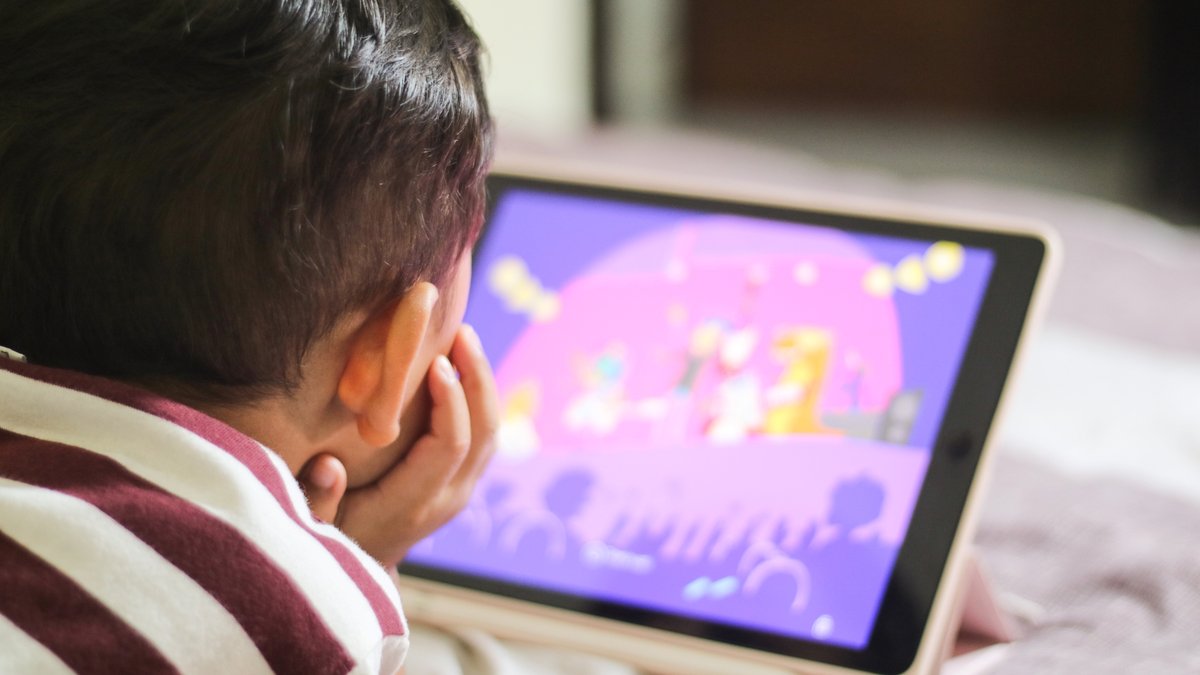 Boy gaming on device