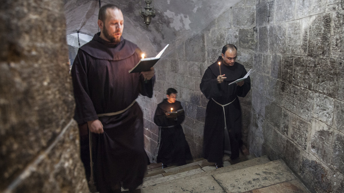 Jerusalem, Israel – November 26, 2013: Franciscan monks in the Church of Holy Sepulchre during their daily precession. – shutterstock_571093945