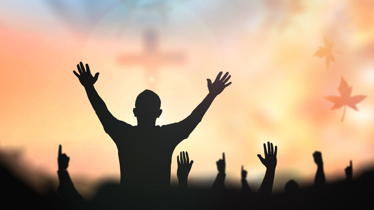 Silhouette people raising hands over blur crown of thorns and the cross on golden autumn sunset background. Thanksgiving, Christmas, Forgiveness, Mercy, Humble, Repentance, Reconcile, Glorify concept.