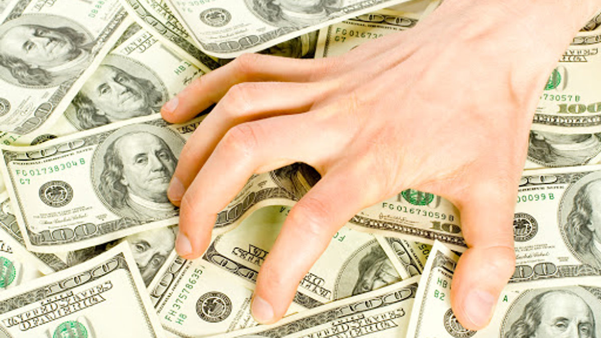 Main dans billets de banque