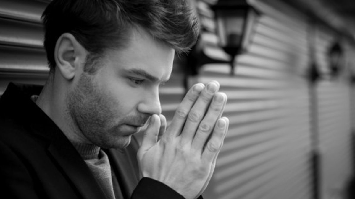 web-young-man-praying-monochrome-blueskyimage-shutterstock_147477785