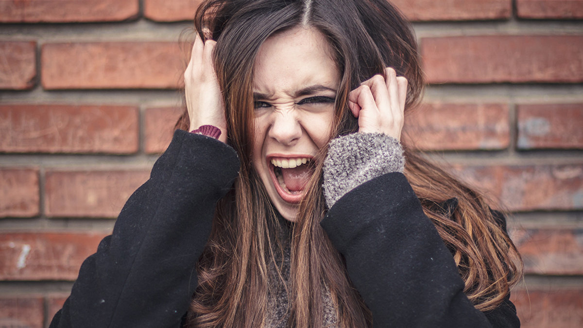 WEB3-WOMAN-BRICK-ANGER-SCREAM-FURIOUS-RAGE-EMOTION-TeodorLazarev-Shutterstock-