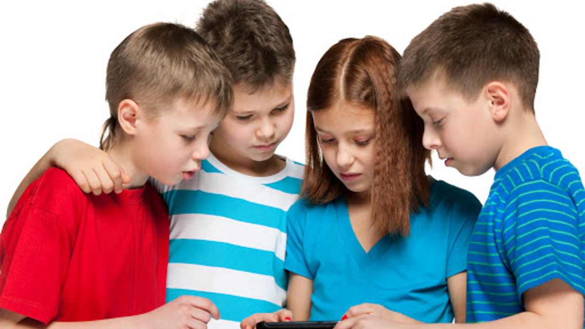 Group of four children are playing with smartphone – it