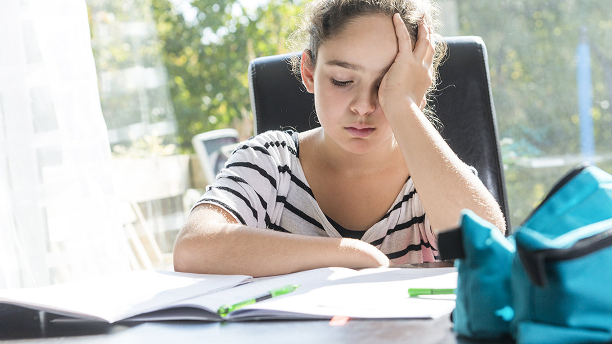 WEB3-CHILD-GIRL-HOMEWORK-SCHOOL-WORK-PEN-NOTEBOOK-UPSET-Shutterstock