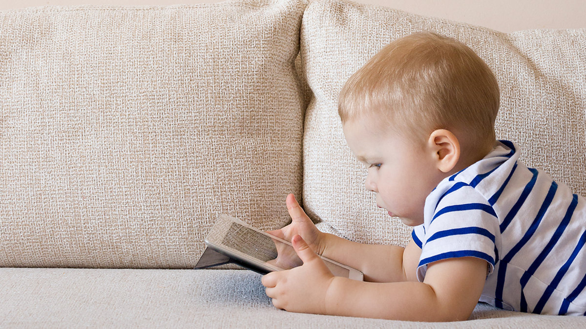 WEB3 LITTLE BOY CHILD COUCH IPAD TABLET Shutterstock