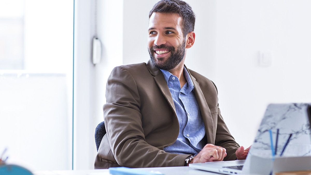 MAN WORKING AT DESK