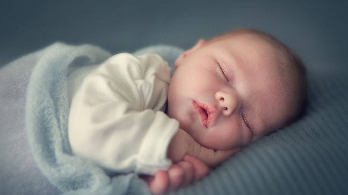 sleeping newborn baby in a wrap