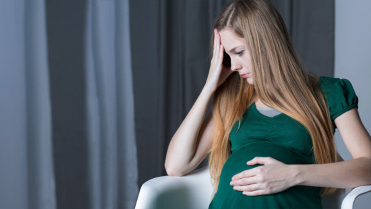web3-mom-pregnant-belly-chair-concerned-sad-shutterstock