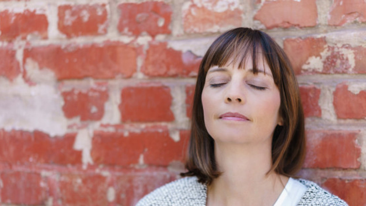 web-woman-pray-introspection-brick-wall-c2a9racornshutterstock1