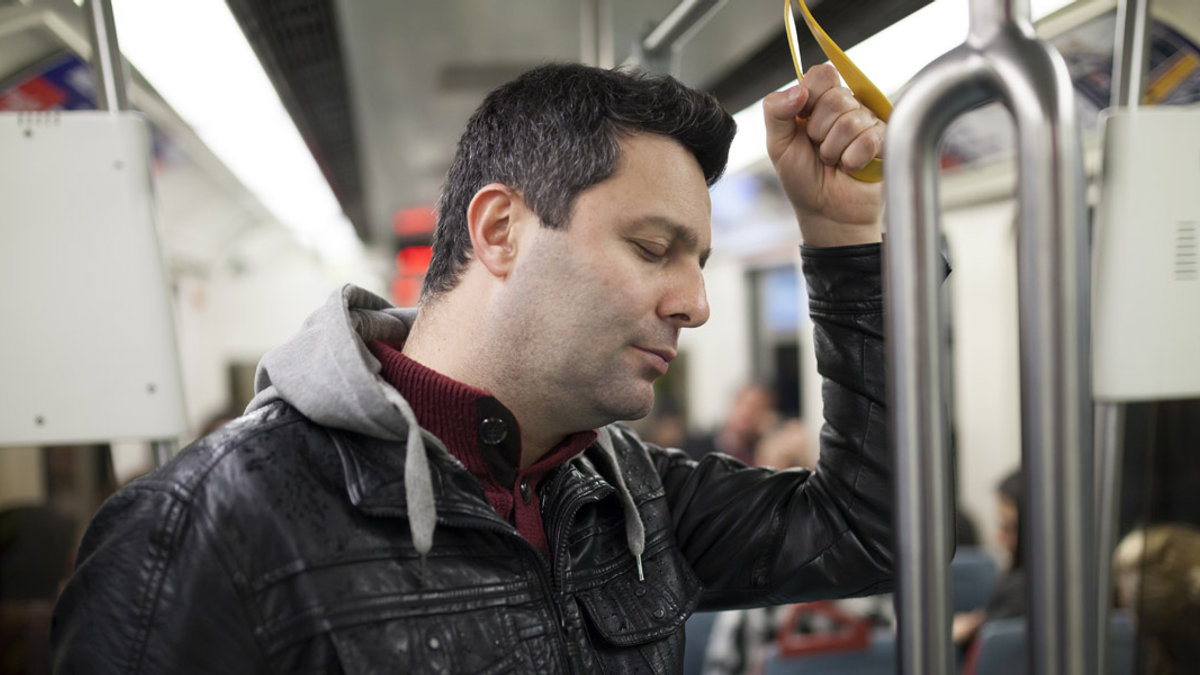 MAN,PRAYING,SUBWAY
