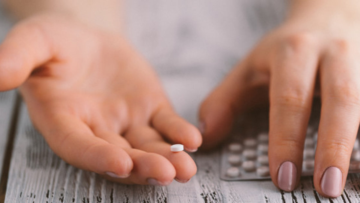 web3-woman-hands-table-pill-birth-control-contraception-shutterstock