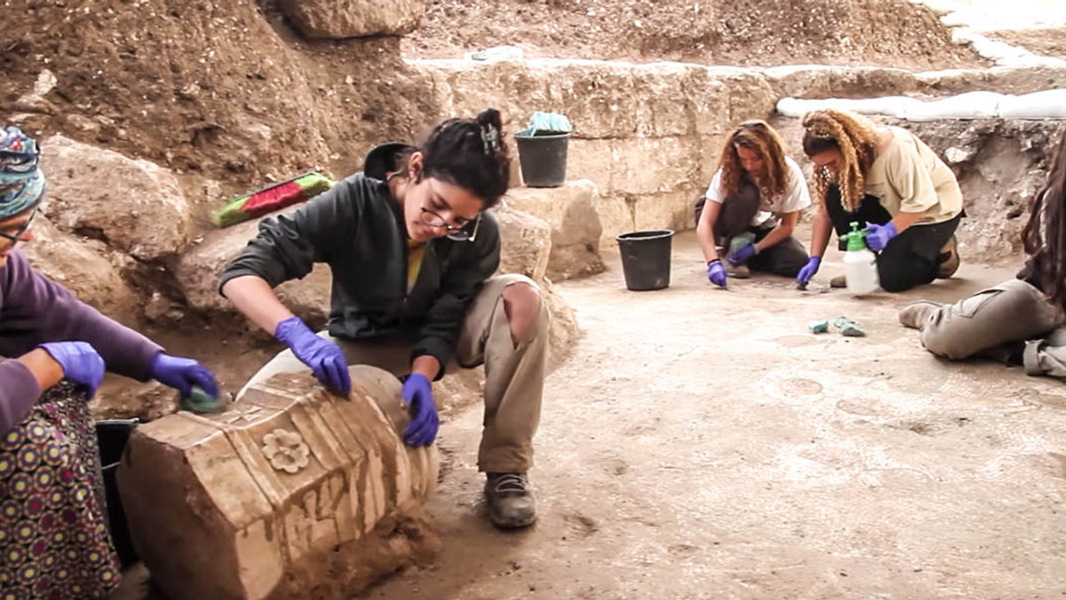 WOMAN WORKING ON STONES
