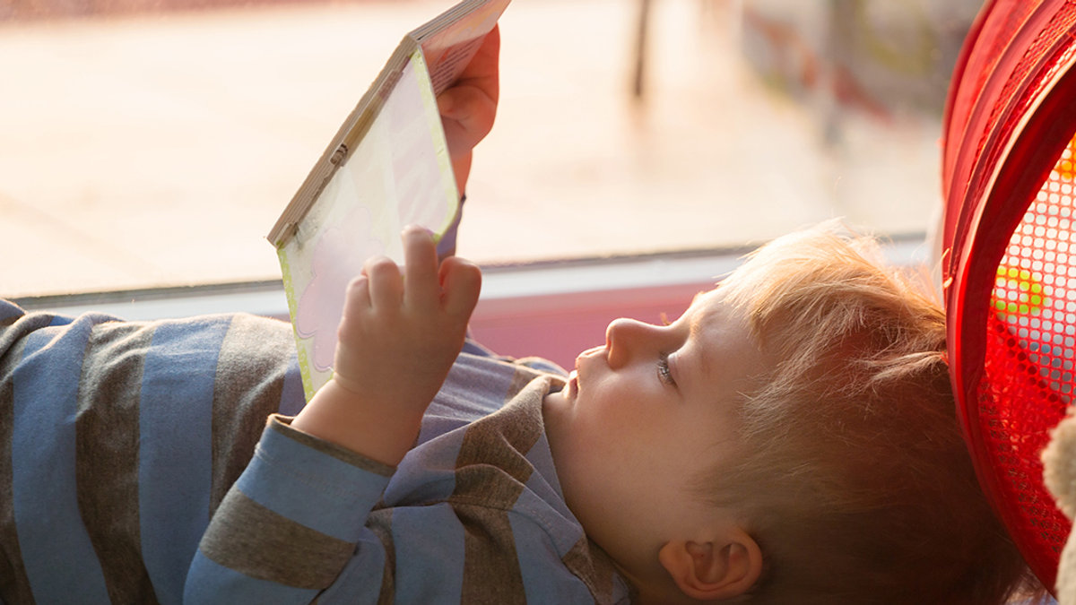 Little boy reading a book
