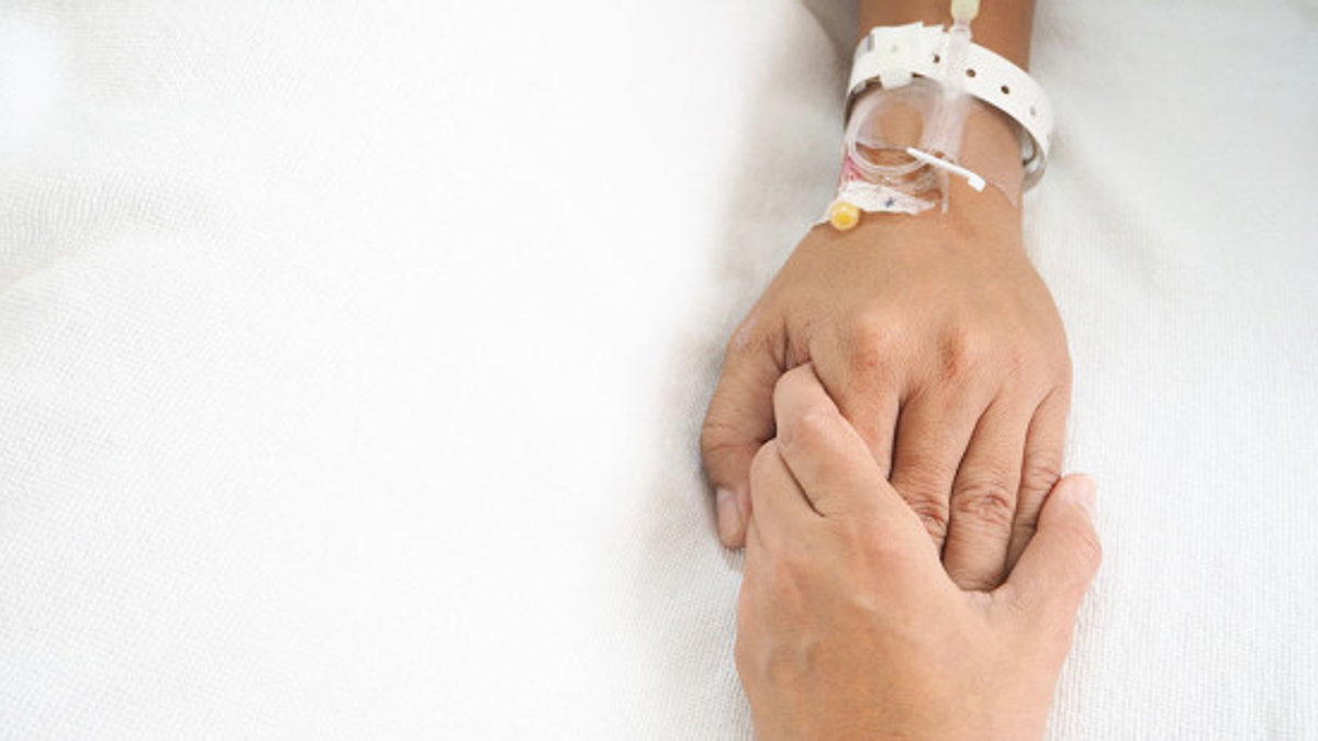 web3-hands-touching-cancer-patient-pain-hospital-bed-shutterstock_509368501-benchawan-suasuk-ai