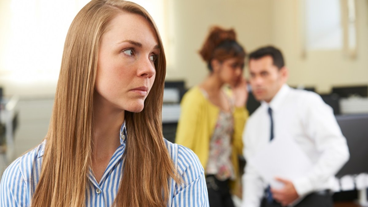 woman Being Gossiped About By Colleagues