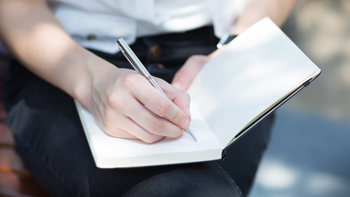 WOMAN WRITING NOTES