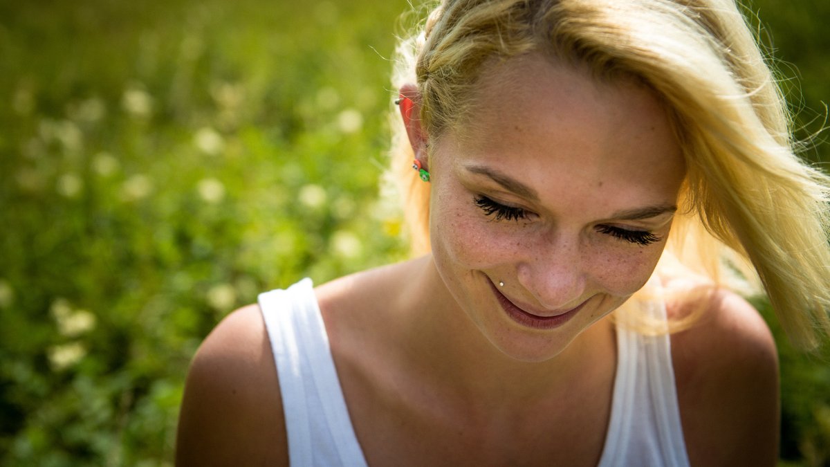 WOMAN SMILING IN THE SUN