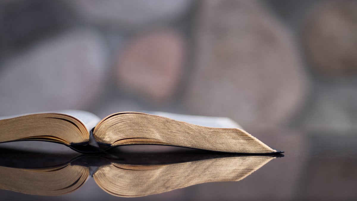 Otwarta Biblia na szklanym stole