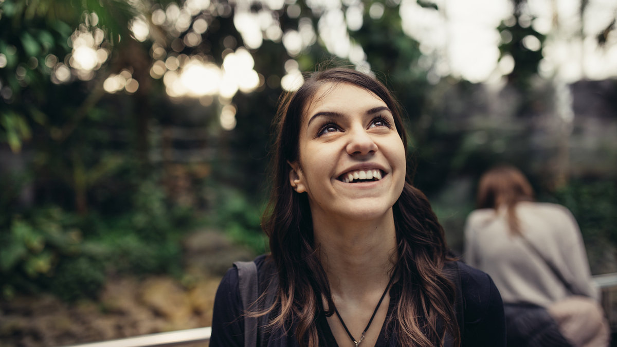 excited woman looking up smiling