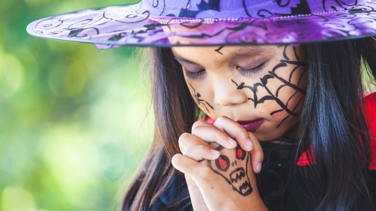 web3-halloween-little-girl-costume-witch-praying-celebration-a3pfamily-shutterstock.jpg