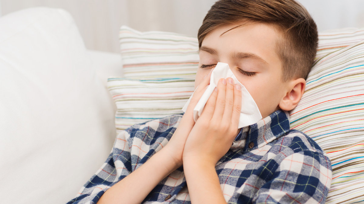 web3-ill-boy-lying-in-bed-and-blowing-his-nose-at-home-shutterstock_358661969.jpg