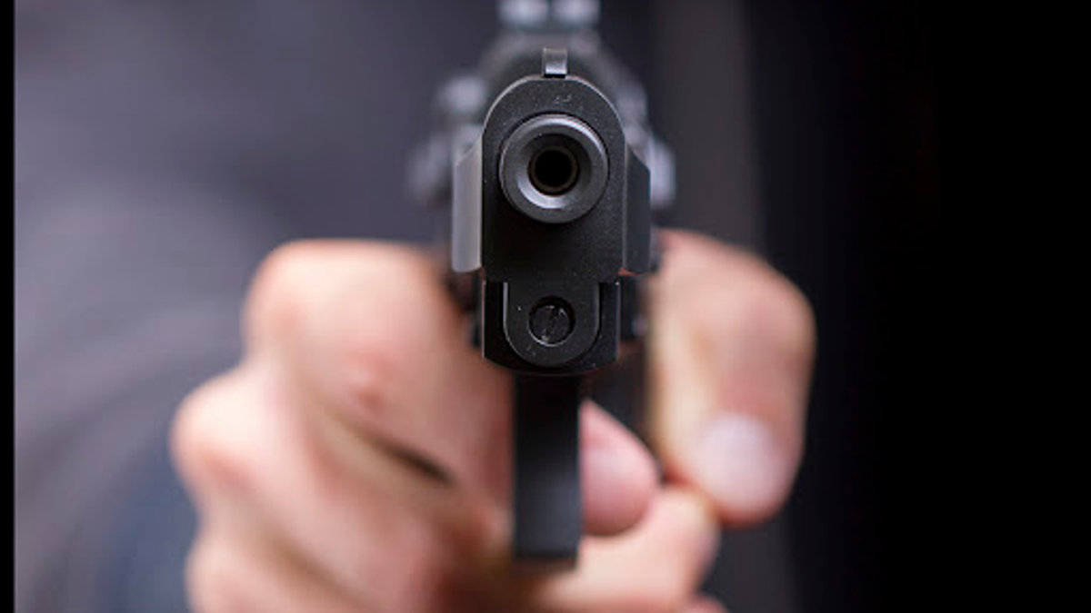 Man with gun © MyImages – Micha / Shutterstock