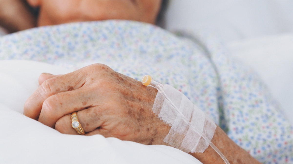 WEB3-Senior-woman-laying-on-bed-in-hospital-roomshes-sick.-Shutterstock_1054837748.jpg