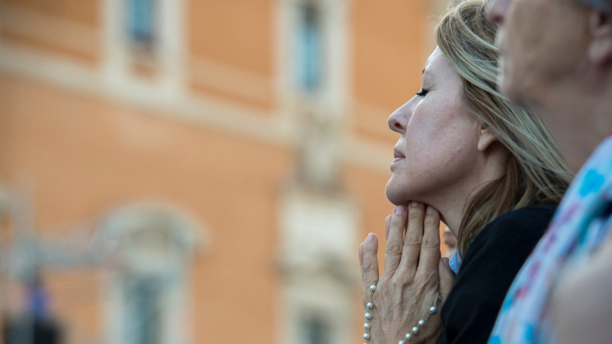 WOMAN PRAYS,