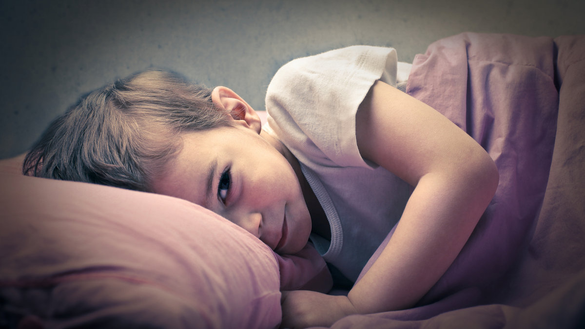 LITTLE BOY SLEEPING IN HIS BED,