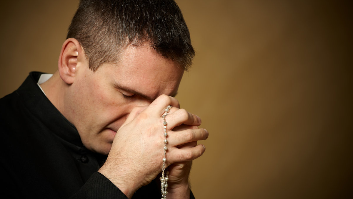 PRAYING PRIEST