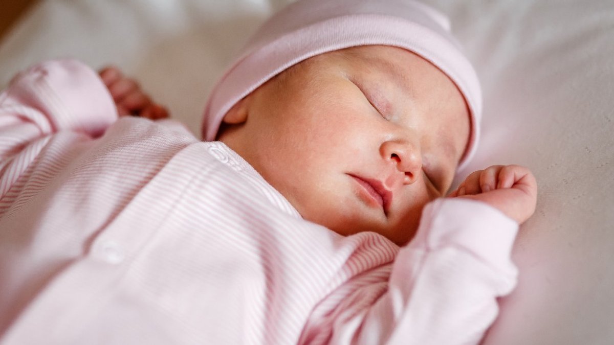 Sleeping baby wearing pink