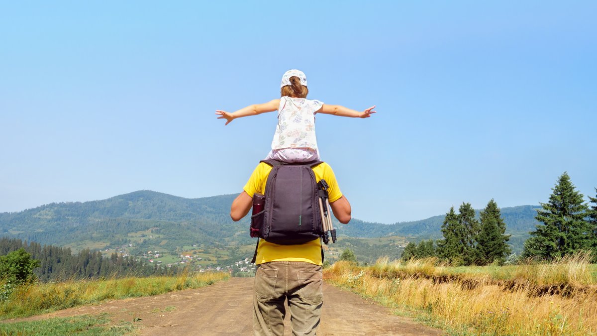 Man with a children walking on a way
