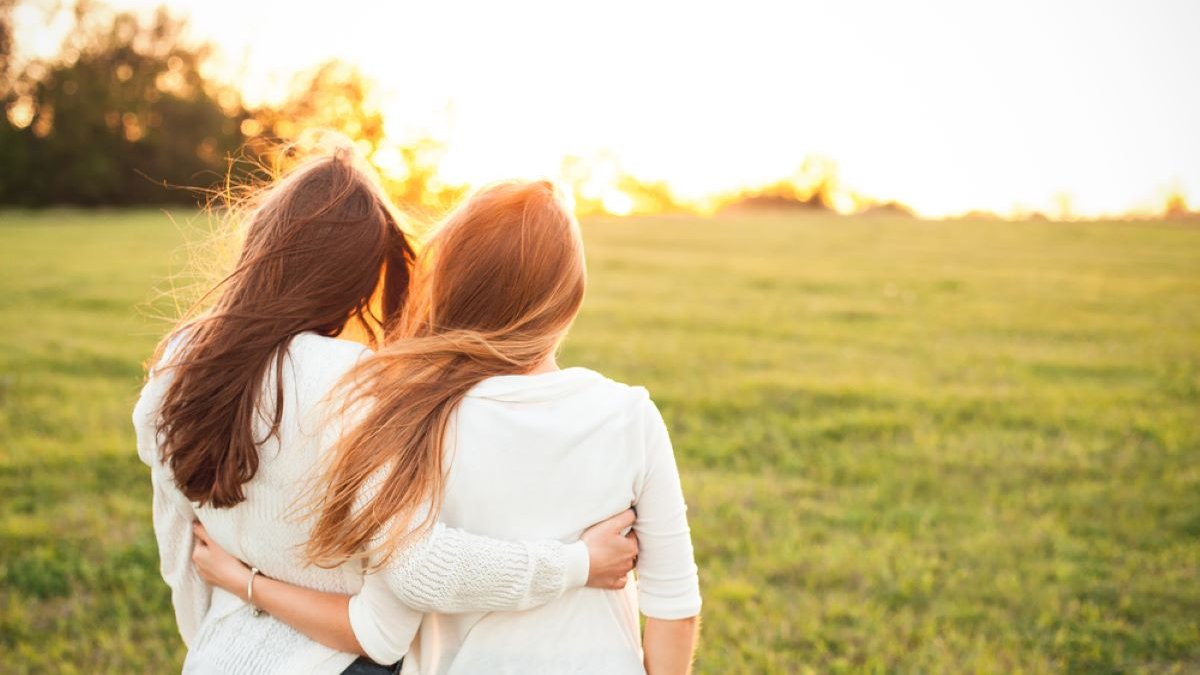 Young women in white sweaters