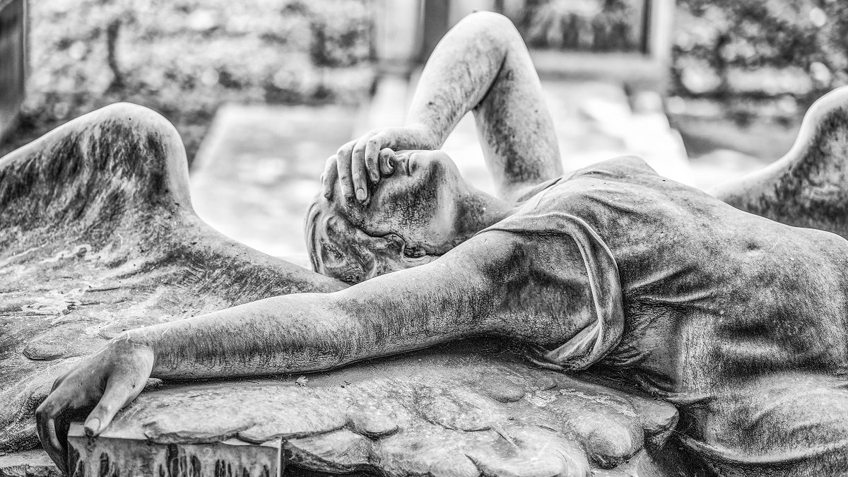 Statue of an angel face palming
