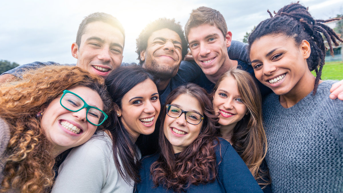 group of young men and women smiling