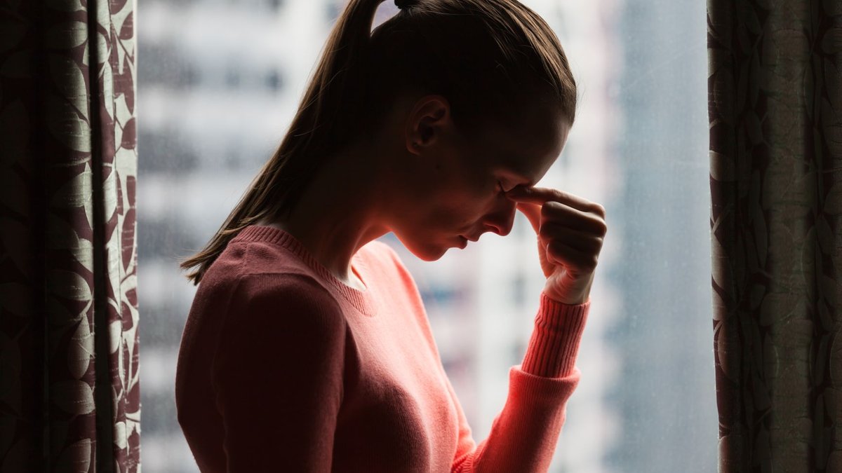 Worried woman in shadow