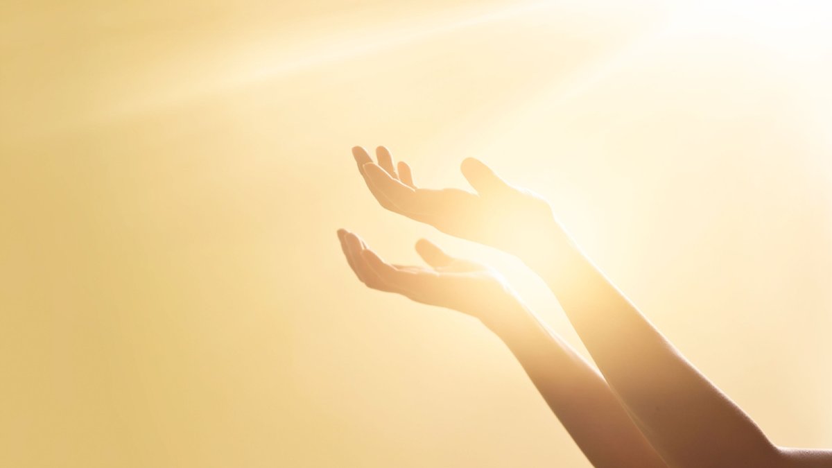 Woman hands praying for blessing from god on sunset background