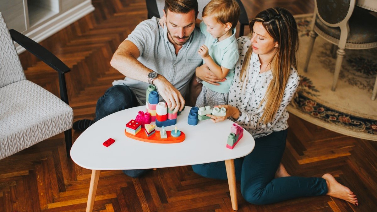 Mom and dad playing game with young child