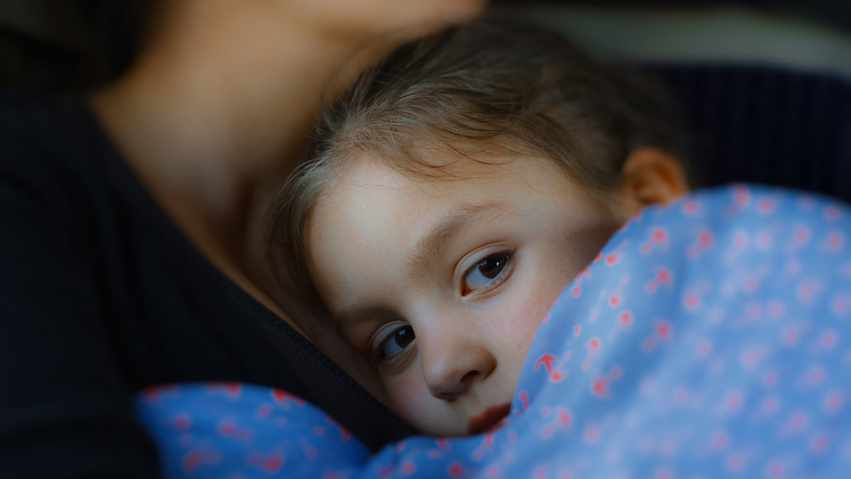 girl cuddle mother neck child blanket