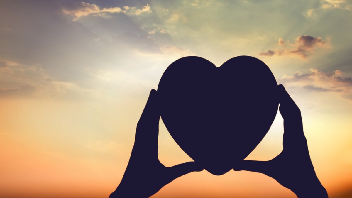 hands holding the sun at dawn