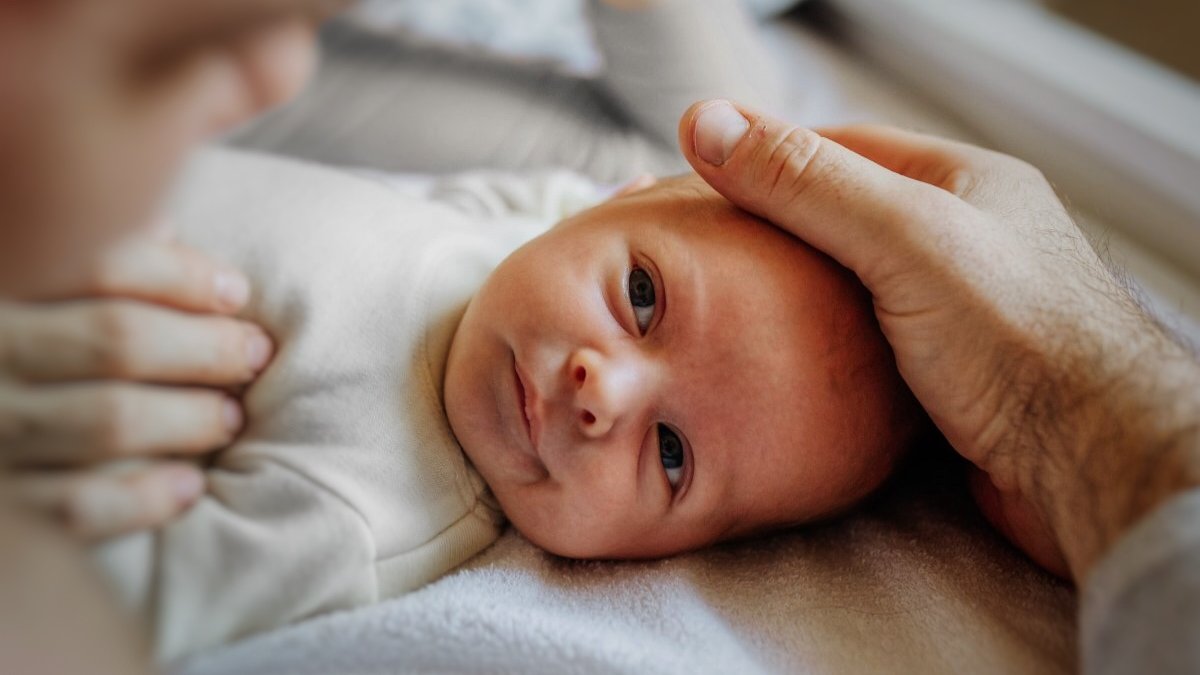 Baby looking up at mom