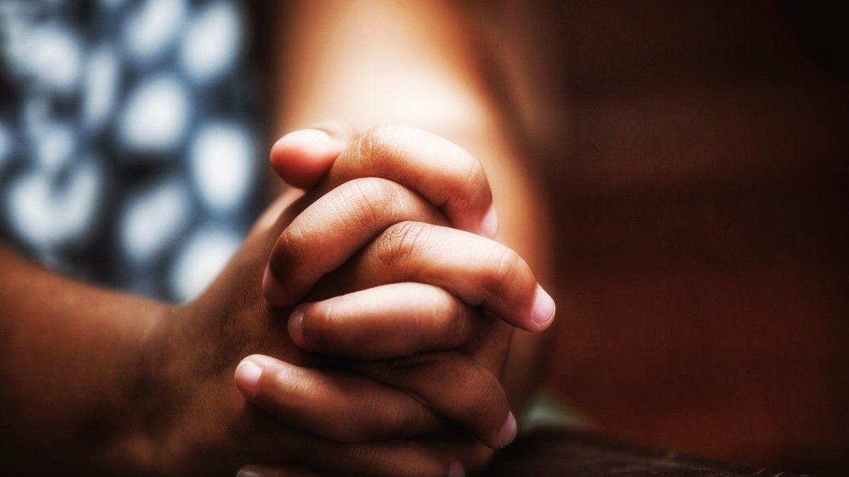 Little girl hands folded in prayer