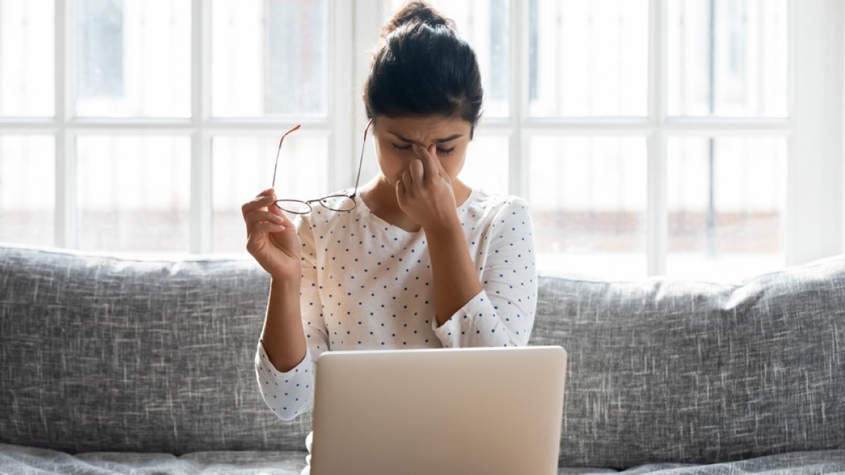 Tired young woman take off glasses massage eyes overwhelmed