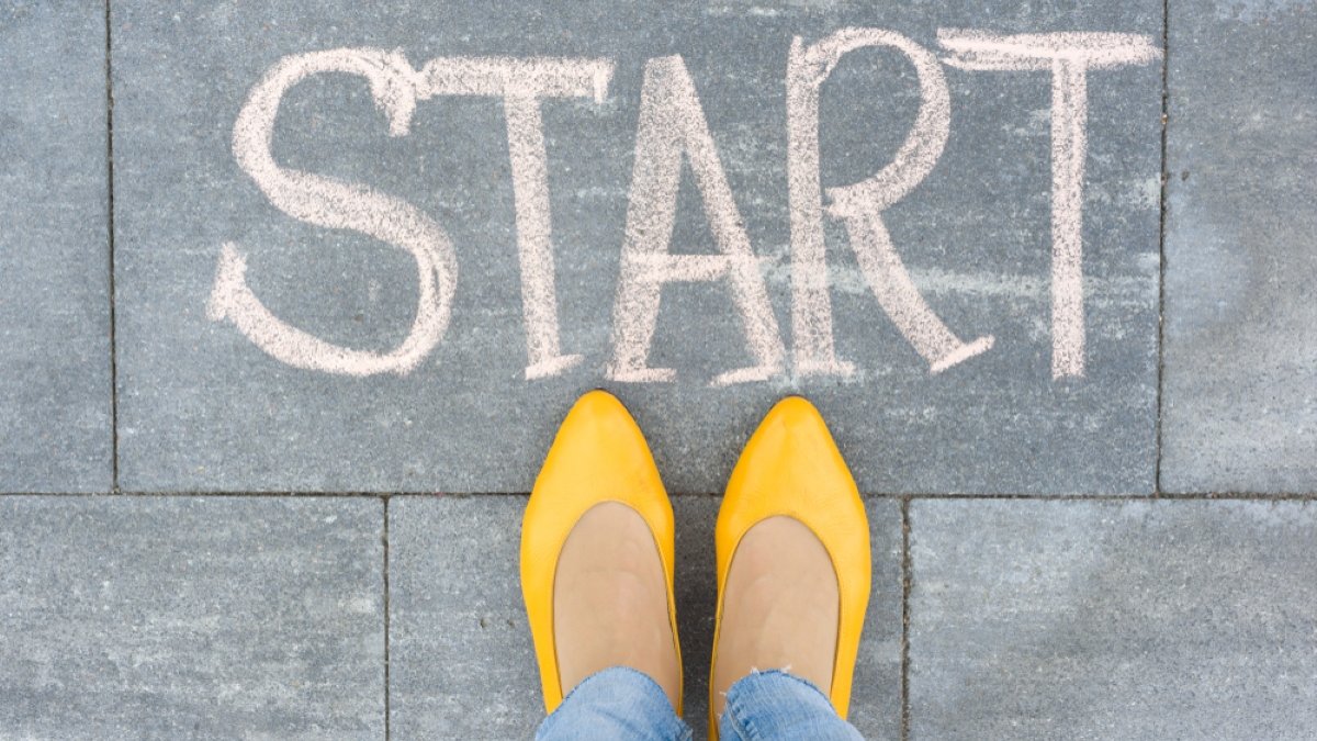 Word start on the asphalt and feet woman