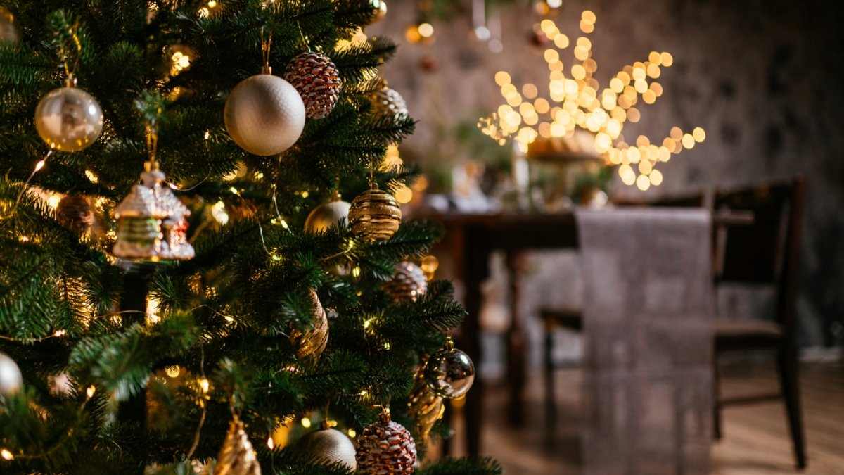 new year cozy home interior with christmas tree and garlands