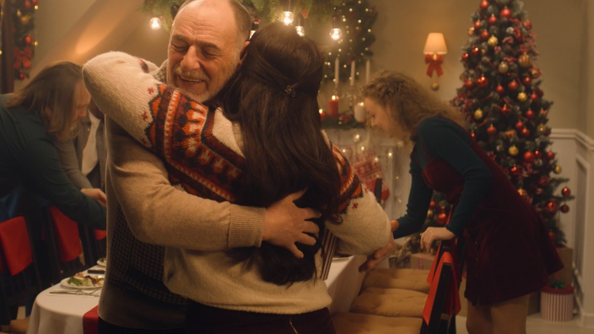 Happy diverse family meeting each other at cozy home for celebrating Christmas or New Year